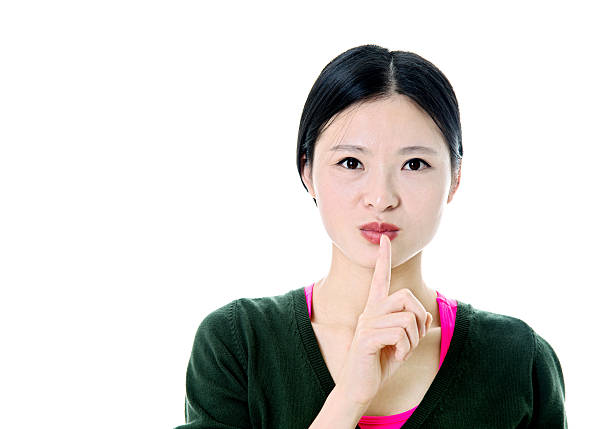 istock Beautiful young with her finger on lips 503198648