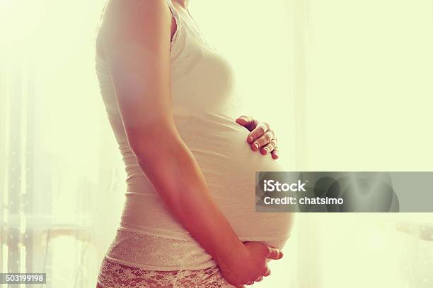 Image Of Pregnant Woman Touching Her Belly With Hands Stock Photo - Download Image Now