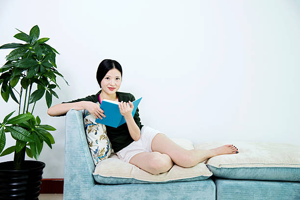istock Reading book in living room 503199390