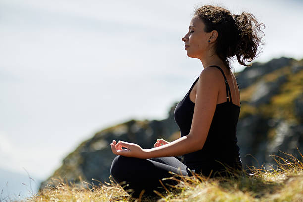 istock Woman practicing yoga on mountain 503199856