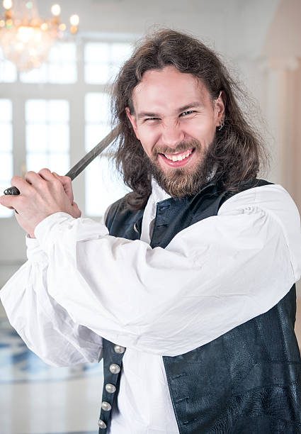 istock Handsome man in medieval clothes threaten with sword 503200392