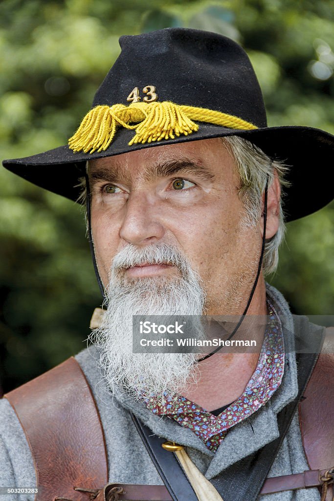American Civil War Confederate Soldier Closeup of an American Civil War reenactor portraying a Confederate unmounted cavalry soldier.  Has the look of a true American cowboy. Adult Stock Photo
