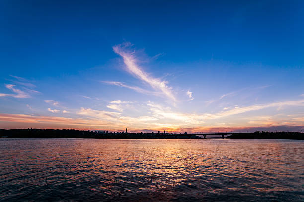 Sunset on the river Dnipro with clouds stock photo