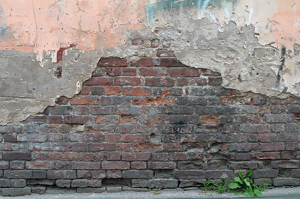 istock Texture of old brick wall with yellow plaster 503203901