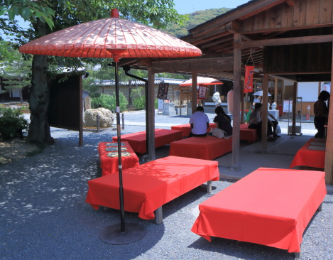 Kyoto Japan - 1 June, 2014: Traditional Japanese street Kiosk with red bench and umbrella in Higashiyama Kyoto Japan.