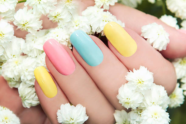Manicure cake. Pastel manicure on female hand with flower Hipsofilas summer nails stock pictures, royalty-free photos & images