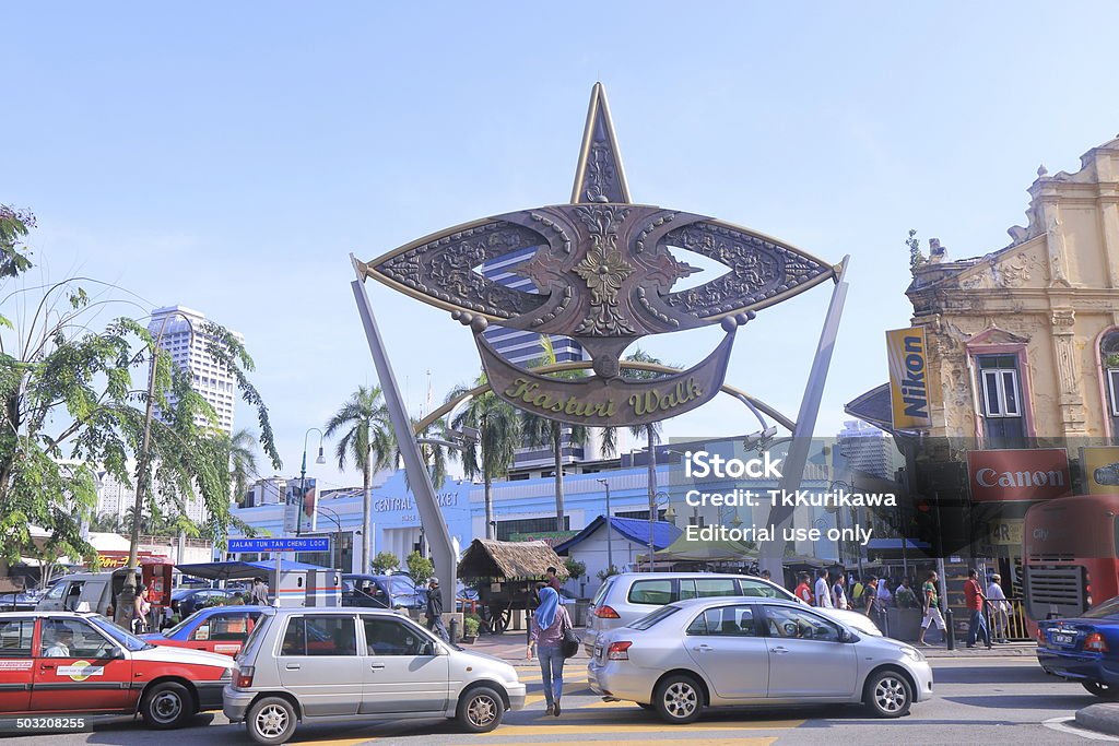 Kasturi walk and Central Market Kuala Lumpur Kuala Lumpur Malaysia - 30 May, 2014: A woman crosses heavy trafic in front of popular tourist spot, Kasturi walk and Central Market in Kuala Lumpur Malaysia. Kuala Lumpur Stock Photo