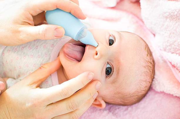 cleaning baby nose cleaning baby nose saline drip stock pictures, royalty-free photos & images