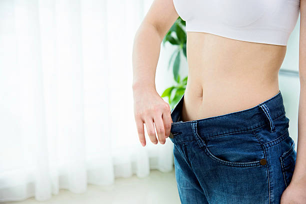 istock Young woman losing weight 503215468