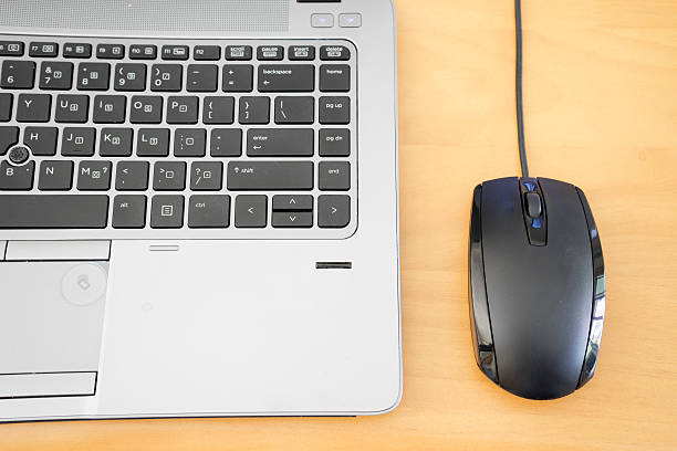 istock keyboard and mouse on wooden table 503219174