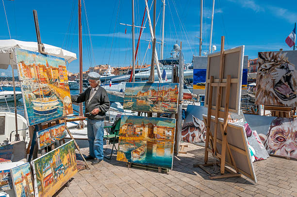 St Tropez, France - April 29th, 2008; The quayside artist market is a popular attraction in the chic tourist village of St Tropez, France