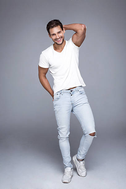 Handsome smiling man wearing jeans and white t-shirt.