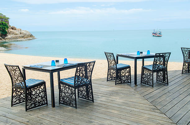 istock Table and chair setting on the beach with blue sky 503220937
