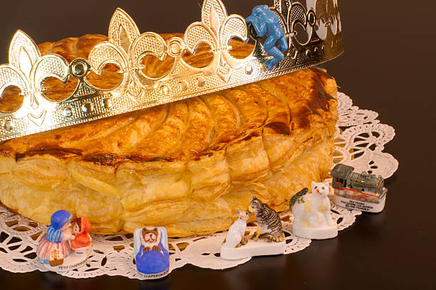 Galette des Rois A traditional French-style king cake, with an assortment of fèves and a crown. These are typically eaten to celebrate Epiphany, the twelfth day of Christmas. galette stock pictures, royalty-free photos & images