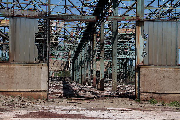 istock Old abandoned dirty empty scary factory interior 503221666