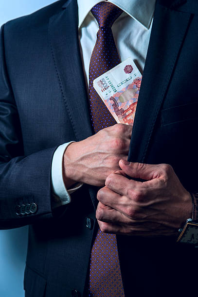 istock Man removes Russian rubles in his suit pocket 503223214