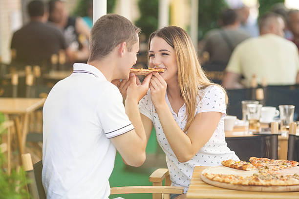 istock Couple Sharing Slice of Pizza 503223602