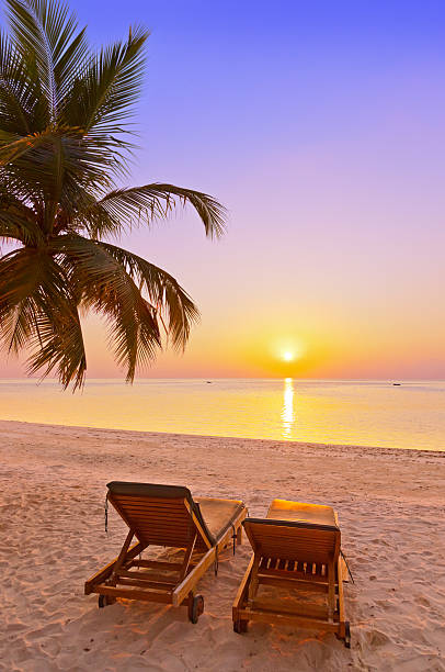 Loungers on Maldives beach Loungers on Maldives beach - nature vacation background water bungalow maldives stock pictures, royalty-free photos & images