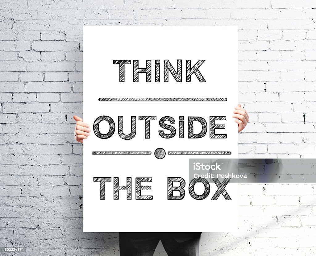 think outside the box businessman holding poster with think outside the box Adult Stock Photo