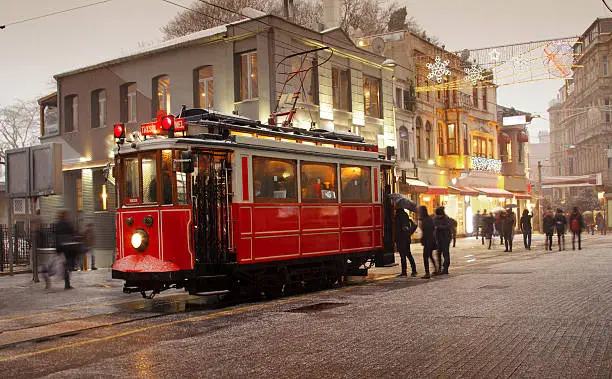 Nostalgic Tramway passing through Istiklal street at christmas night.