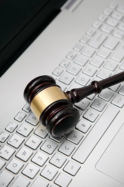 istock Wooden judge hammer on laptop computer white keyboard 503225950
