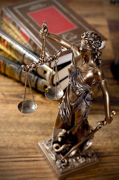 istock Law concept with Themis and books in background 503226040