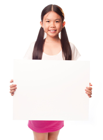 Portrait of cute girl holding blank paper