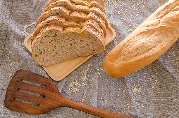 istock Loaf of sliced bread on wooden background 503227004