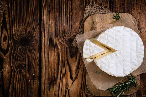 Creamy Camembert on wooden background Creamy Camembert on rustic wooden background (detailed close-up shot) Slective Focus stock pictures, royalty-free photos & images