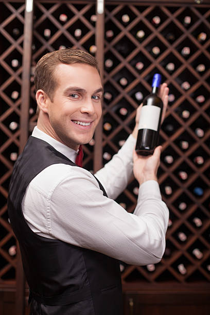 istock Handsome male waiter is analyzing quality of drink 503238568