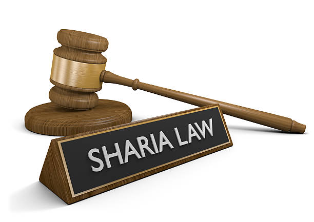 Court concept for Islamic Sharia laws and practices Wooden court gavel next to a sign that says Sharia Law, rendered in 3D over a white background. sharia stock pictures, royalty-free photos & images