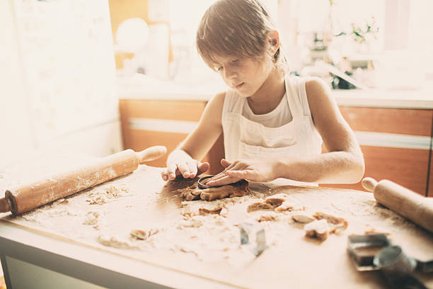 istock Portrait of young boy cutting dough 503238848