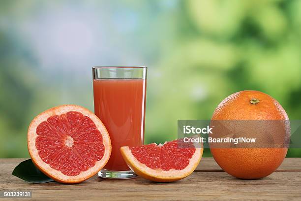 Grapefruit Juice And Fresh Grapefruits In Summer Stock Photo - Download Image Now - Drinking, Grapefruit Juice, Citrus Fruit