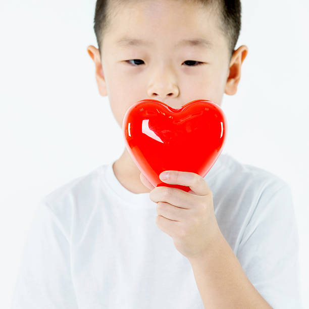 istock Little boy holding a red heart 503239516