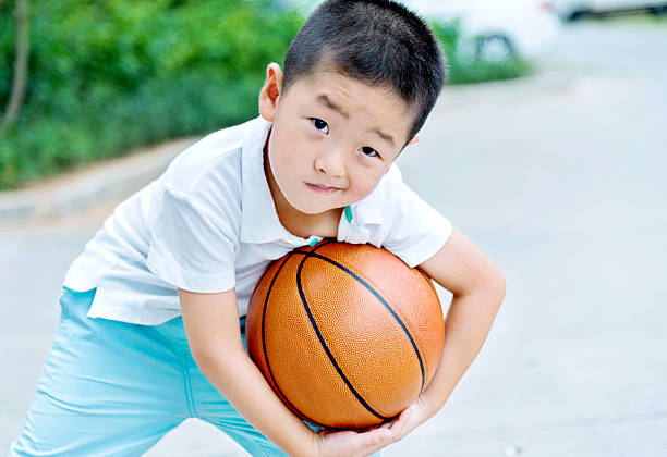 istock Little boy holding a basketball 503239920