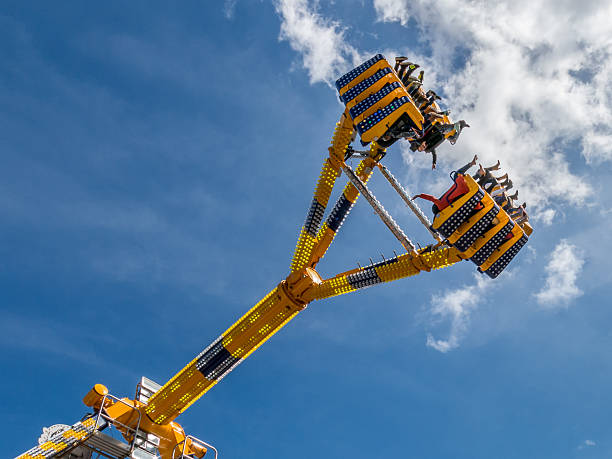 Hilversum, Netherlands - April 27, 2015: People in a vertical ride in the sky in Ultimate on fun fair on King's Day in the Netherlands