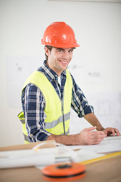 istock foreman in his office reviewing building plans 503241103