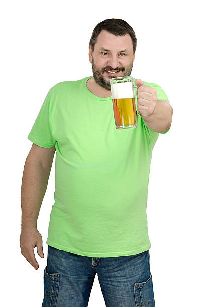 Cheerful bearded man offering you tankard lager. Man holding mug beer in left hand on white background