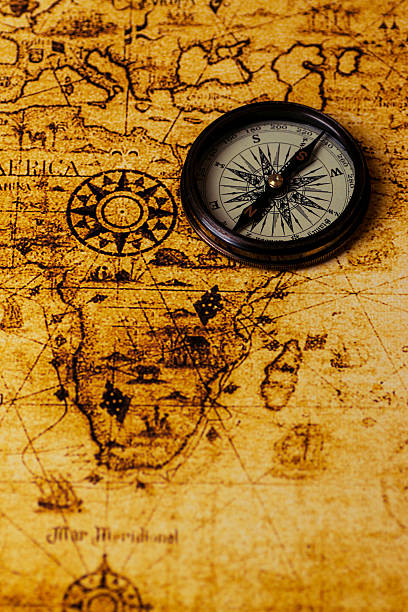 istock vintage lifestyle concept: retro compass on antique world map 503243424