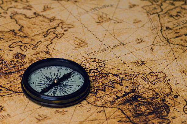 istock vintage lifestyle concept: retro compass on antique world map 503243454