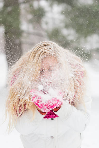 istock Girl blows snow from gloves 503244692