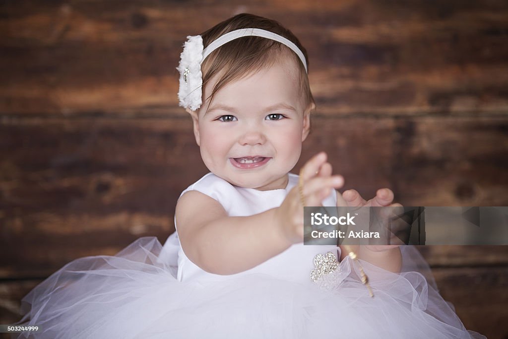 baby girl wearing a white dress baby girl on her baptism Baptism Stock Photo