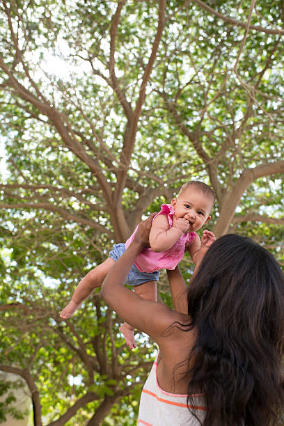 игривый мать. - babies and children cheerful low angle view vertical стоковые фото и изображения