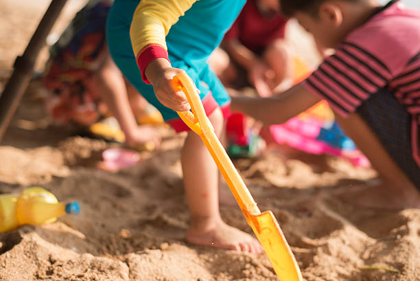 istock Little boy playing sand on the beach summer time 503245812
