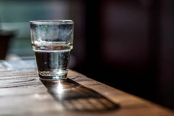 Photo of water glass on wooden table