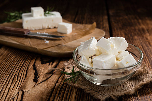 Fresh Feta Cheese Fresh Feta Cheese (detailed close-up shot) on vintage background white cheese stock pictures, royalty-free photos & images