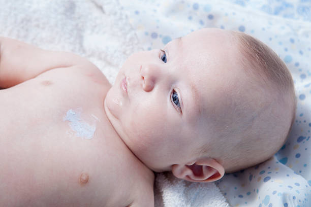 istock Mother applying cream over baby boy 503250284