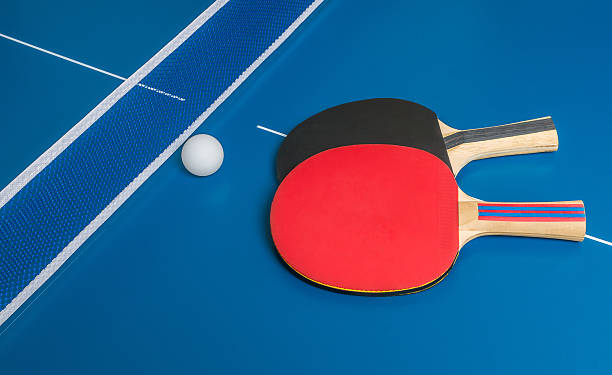 istock Ping pong challenge. Table tennis rackets on blue table. 503250908