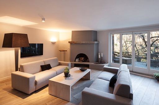 Interior of house, modern comfortable living room with fireplace