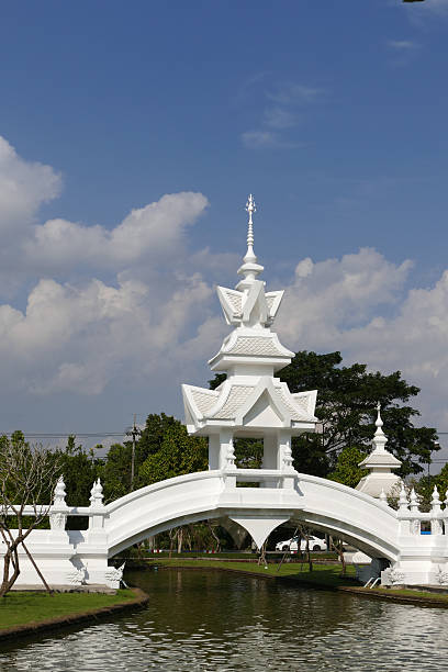 white gazebo on the bridge across the pond in temple in Thailand